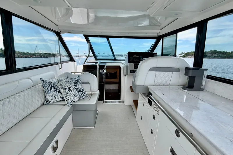 Slide: The Image of Interior of 2022 Regal 36 XO yacht with luxurious seating and modern helm. - 18