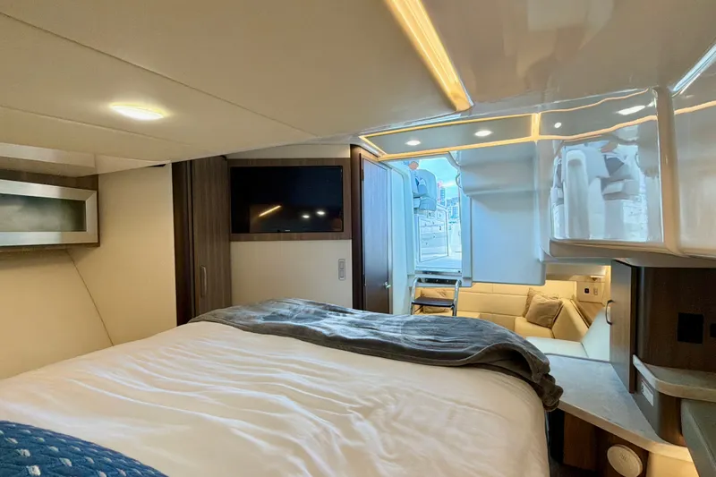 Slide: The Image of Luxurious interior of 2022 Regal 36 XO yacht with cozy bed and modern amenities. - 36