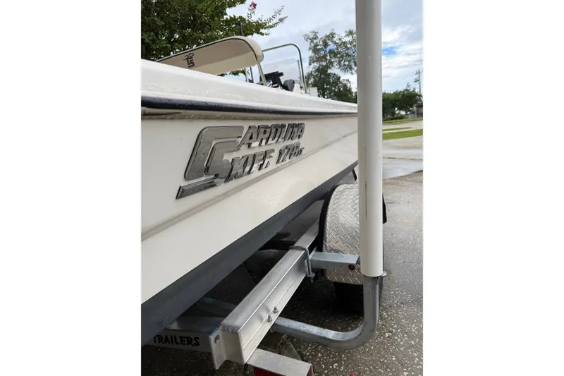 Slide: The Image of 2022 Carolina Skiff 178 CC boat on trailer, side view with logo visible. - 8