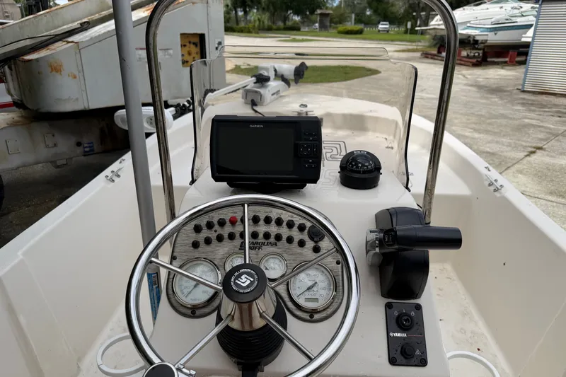 Slide: The Image of Center console of 2022 Carolina Skiff 178 CC boat with steering wheel and navigation equipment. - 5