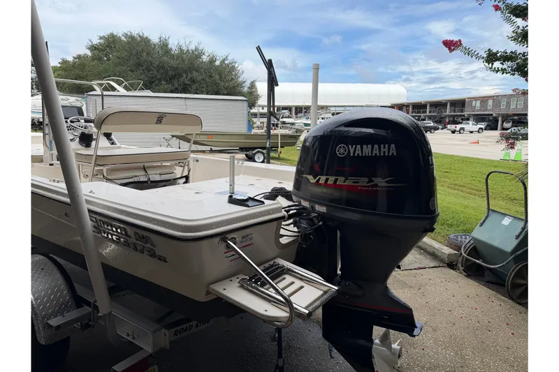 Slide: The Image of 2022 Carolina Skiff 178 CC boat with Yamaha VMAX outboard motor in a marina setting. - 4