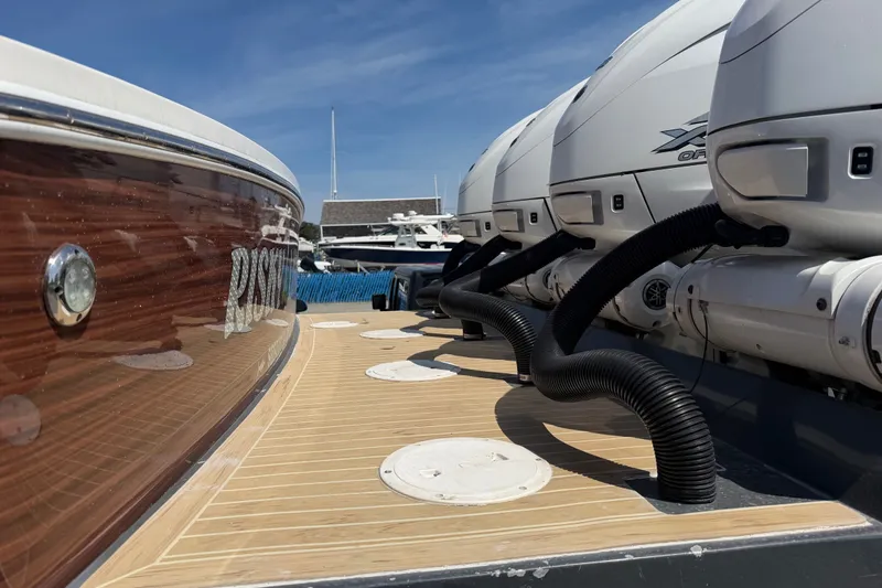 Slide: The Image of 2019 Regulator 41 boat with powerful outboard engines docked under clear blue sky. - 14