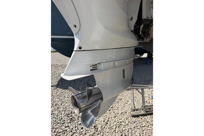 Slide: The Image of Close-up of a 2019 Regulator 41 boat propeller on gravel surface. - 21