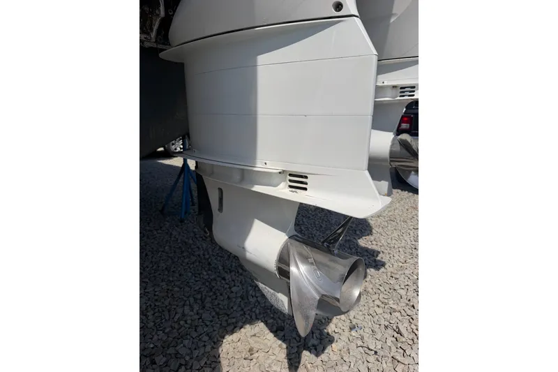 Slide: The Image of Close-up of a 2019 Regulator 41 boat propeller on gravel surface. - 24
