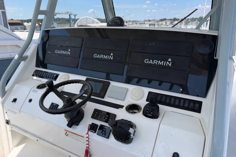 Slide: The Image of Helm of 2019 Regulator 41 boat with Garmin navigation displays and controls. - 29