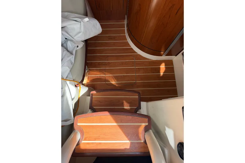 Slide: The Image of Interior view of 2019 Regulator 41 boat with wooden flooring and steps. - 46