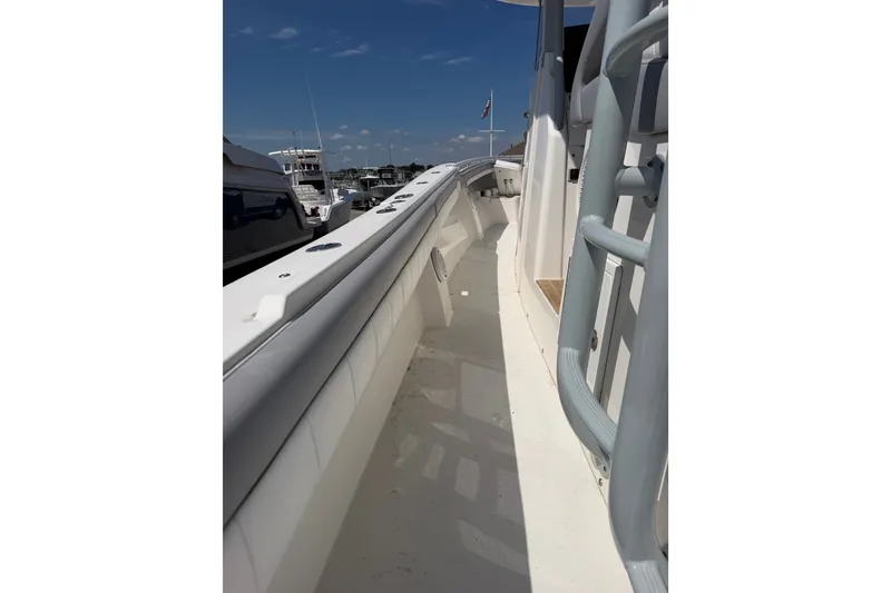 Slide: The Image of 2019 Regulator 41 boat deck view with clear skies and marina background. - 38