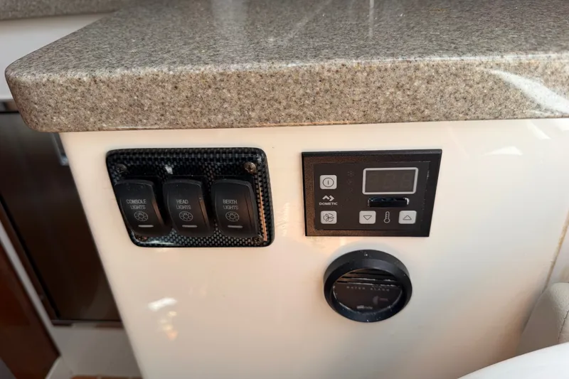 Slide: The Image of Control panel on 2019 Regulator 41 boat with switches and digital display. - 53