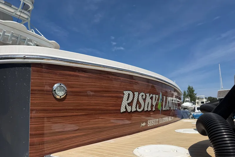 Slide: The Image of 2019 Regulator 41 boat with "Risky Limits" name, docked under clear blue sky. - 13