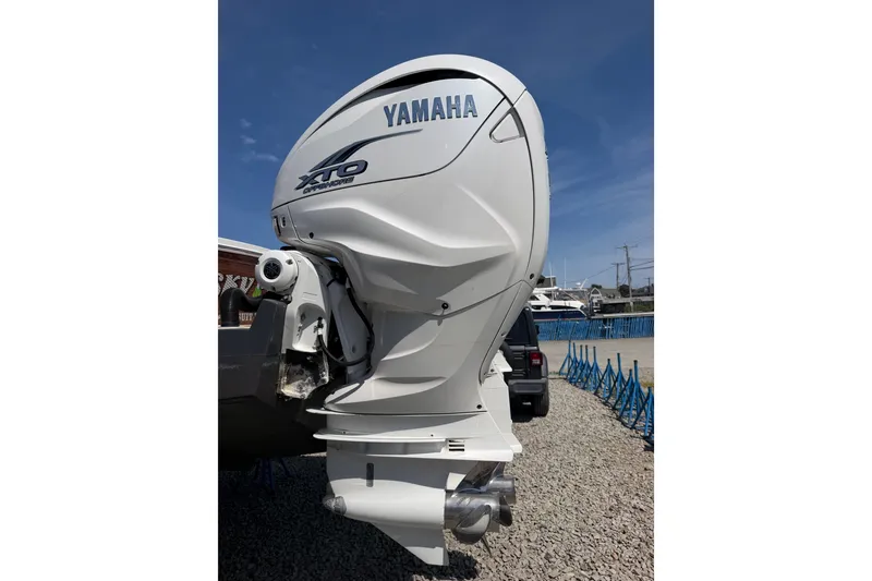 Slide: The Image of Yamaha XTO Offshore outboard motor on a 2019 Regulator 41 boat, parked on gravel. - 20