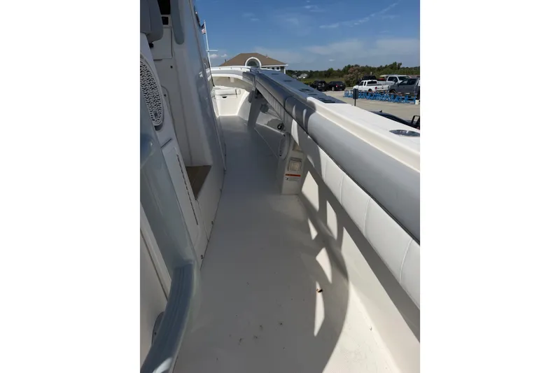 Slide: The Image of 2019 Regulator 41 boat deck with white railing and clear sky background. - 37