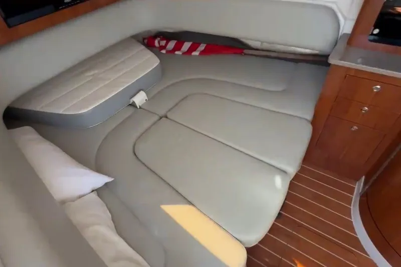 Slide: The Image of 2019 Regulator 41 cabin interior with cushioned seating and wooden cabinetry. - 49