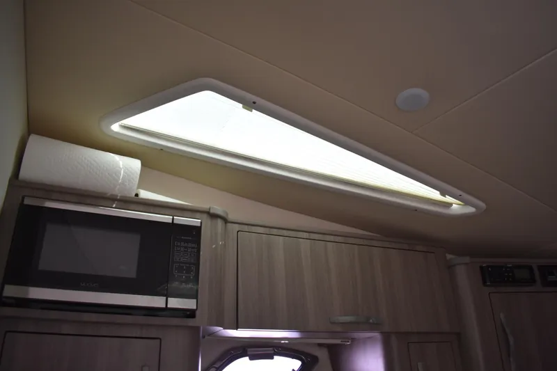 Slide: The Image of Interior of 2020 Regal 35 Sport Coupe with microwave and skylight. - 26