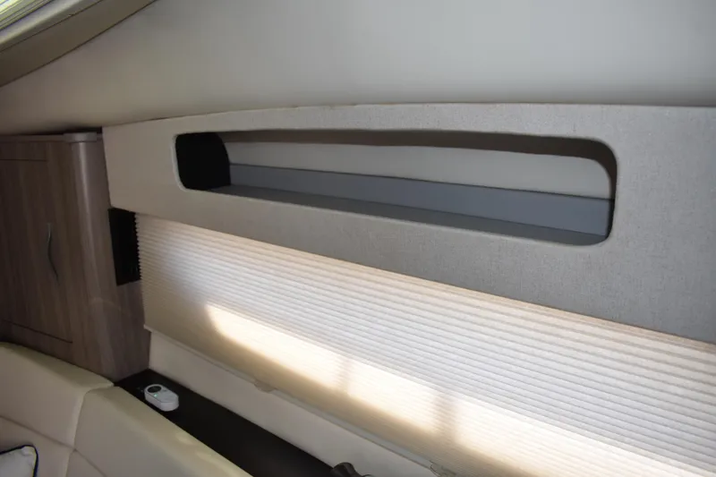 Slide: The Image of Interior of 2020 Regal 35 Sport Coupe with modern storage and window shade. - 28