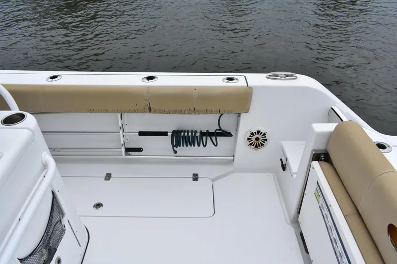 Slide: The Image of 2017 Sportsman Open 312 Center Console boat interior with seating and coiled hose. - 13