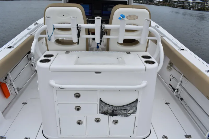 Slide: The Image of 2017 Sportsman Open 312 Center Console boat interior with rod holders and storage compartments. - 11