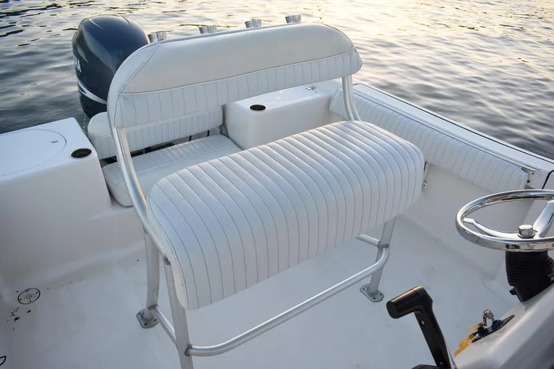Slide: The Image of 2007 Tidewater 216 CC Adventure boat interior with white seating and steering wheel. - 9