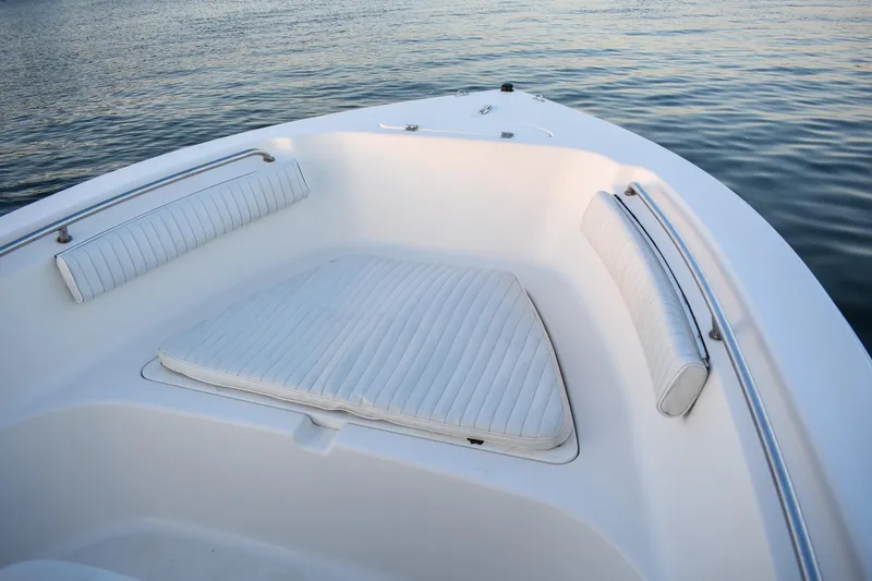 Slide: The Image of 2007 Tidewater 216 CC Adventure boat with cushioned seating, on calm water. - 5