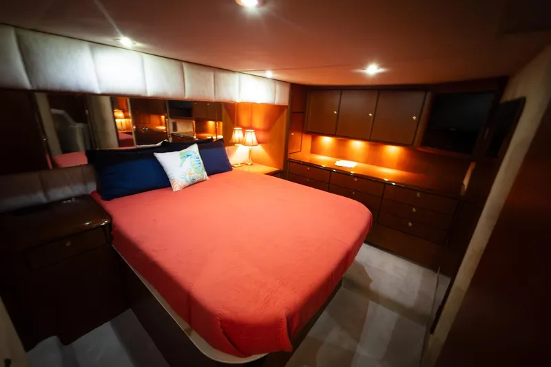 Slide: The Image of Luxurious bedroom interior of 1999 Ocean Yachts 56 Super Sport with warm lighting. - 20