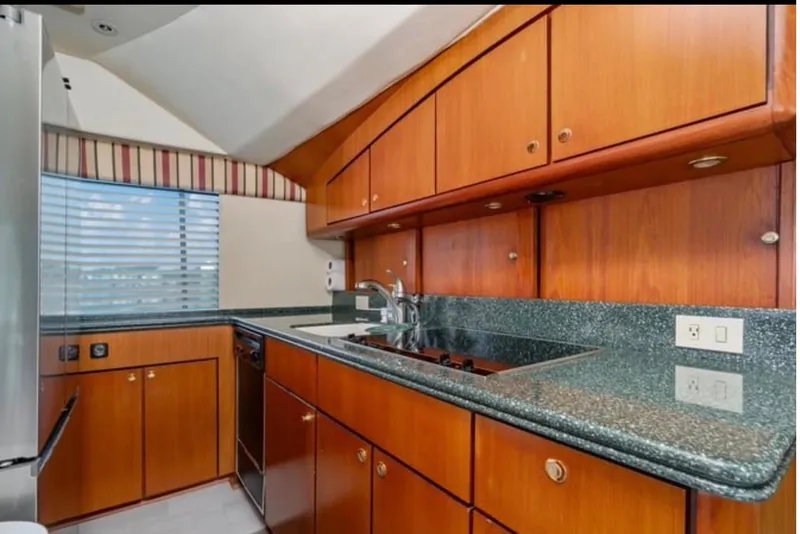 Slide: The Image of 1999 Ocean Yachts 56 Super Sport kitchen with wood cabinets and granite countertops. - 15