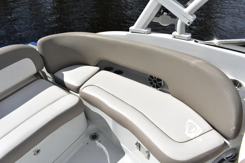 Slide: The Image of 2019 Crownline Eclipse E255 SURF boat interior with beige seating and cup holders. - 16