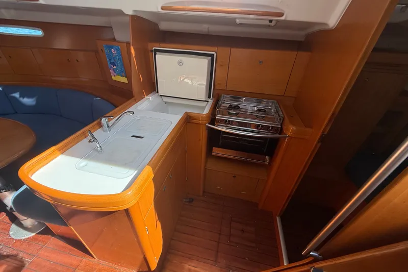 Slide: The Image of Interior of 2006 Beneteau First 44.7 yacht with kitchen and seating area. - 25