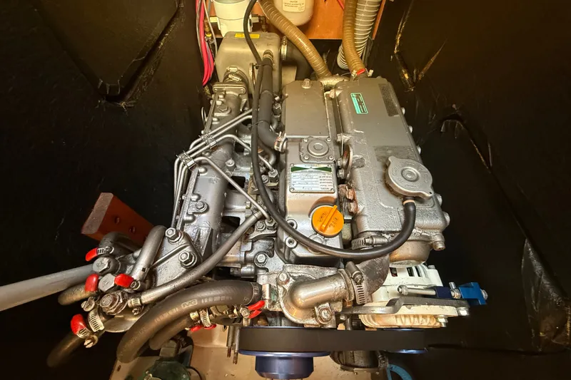Slide: The Image of Engine compartment of a 2006 Beneteau First 44.7 sailboat, showcasing detailed mechanical components. - 38