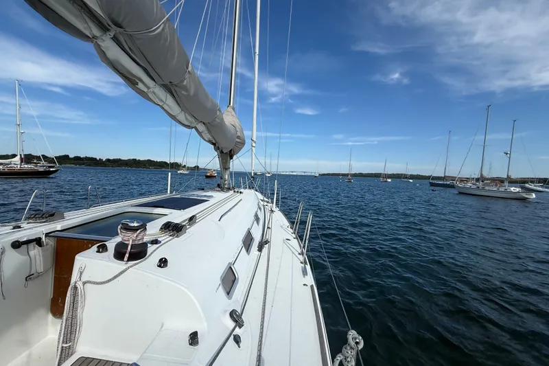 Slide: The Image of Sailing on a 2006 Beneteau First 44.7 yacht in a serene harbor setting. - 12