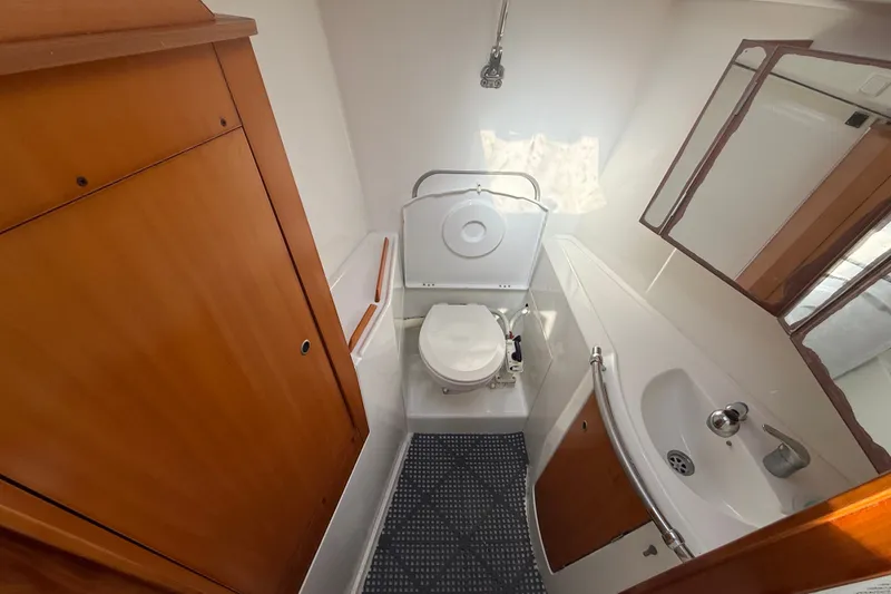 Slide: The Image of Compact bathroom in a 2006 Beneteau First 44.7 yacht with wooden cabinetry and modern fixtures. - 37