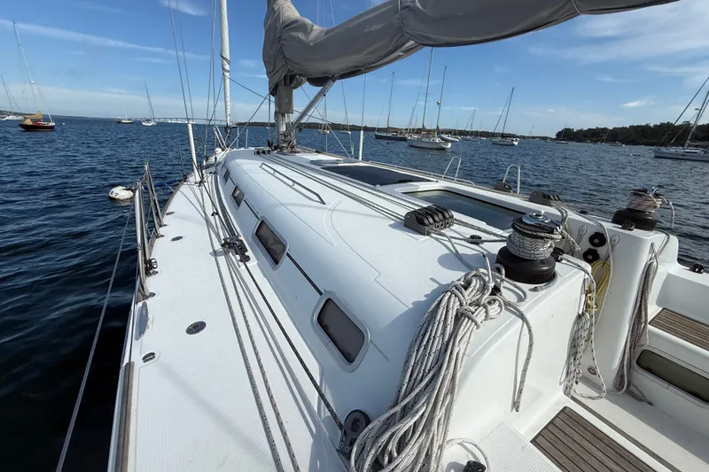 Slide: The Image of 2006 Beneteau First 44.7 sailboat deck view, anchored in a serene harbor. - 11