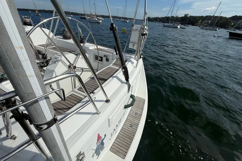 Slide: The Image of 2006 Beneteau First 44.7 sailboat docked in a scenic marina setting. - 5