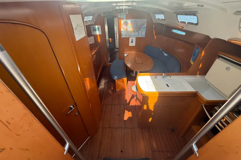 Slide: The Image of Interior of 2006 Beneteau First 44.7 yacht with wooden finish and compact kitchen. - 21