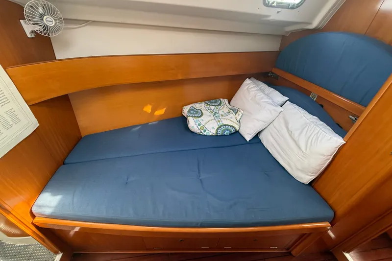 Slide: The Image of Cozy cabin bed with blue bedding in 2006 Beneteau First 44.7 sailboat. - 35