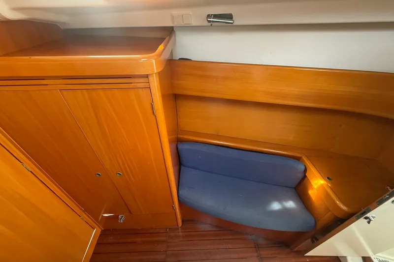 Slide: The Image of Interior of 2006 Beneteau First 44.7 yacht with wooden cabinetry and blue seating. - 36