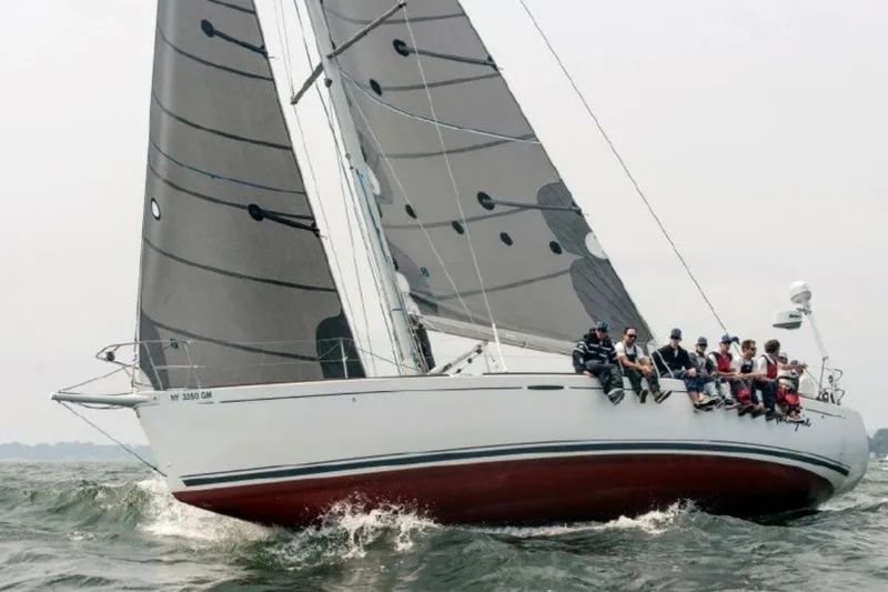 The Image of 2006 Beneteau First 44.7 sailboat with crew navigating choppy waters. - 1