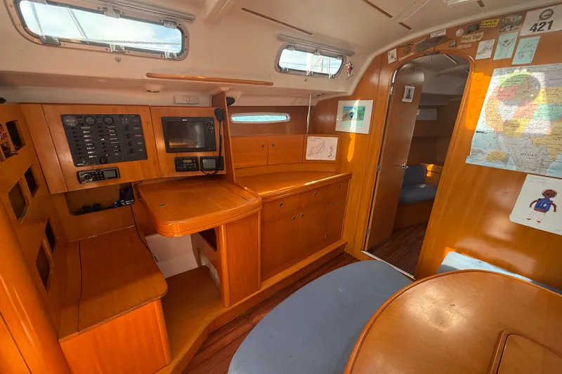 Slide: The Image of Interior of 2006 Beneteau First 44.7 sailboat with navigation station and wooden cabinetry. - 30