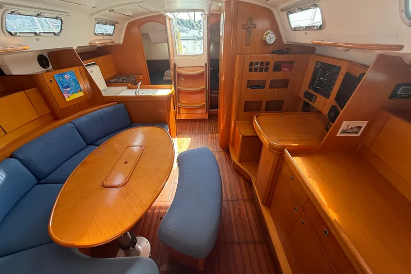 Slide: The Image of Interior of 2006 Beneteau First 44.7 yacht with wooden furnishings and blue seating. - 24