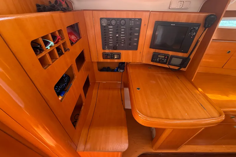 Slide: The Image of Navigation station of 2006 Beneteau First 44.7 yacht with control panel and storage. - 31