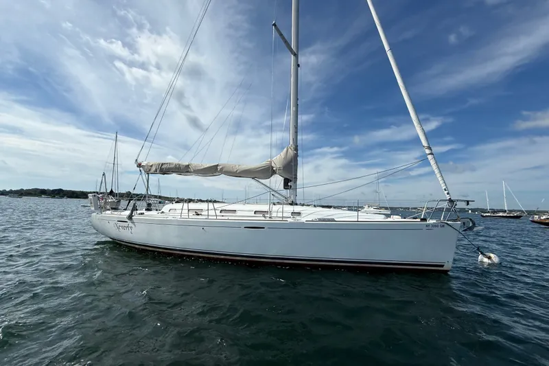 Slide: The Image of 2006 Beneteau First 44.7 sailboat on water under blue sky. - 1
