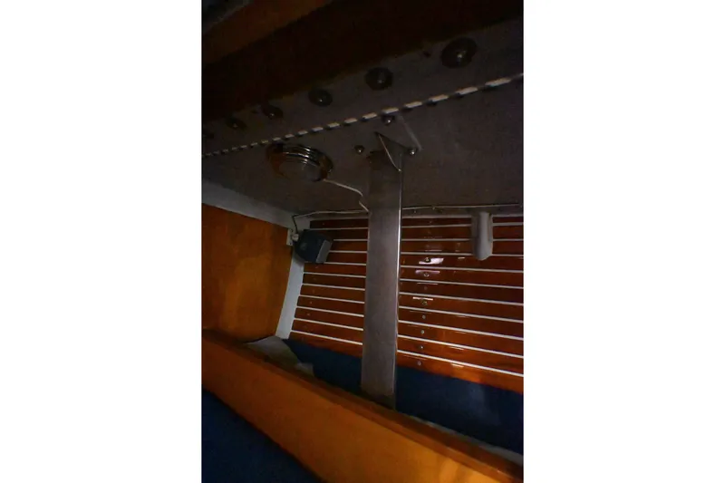 Slide: The Image of Interior view of a 1992 Santa Cruz 52 sailboat, featuring wooden paneling and metal fixtures. - 31