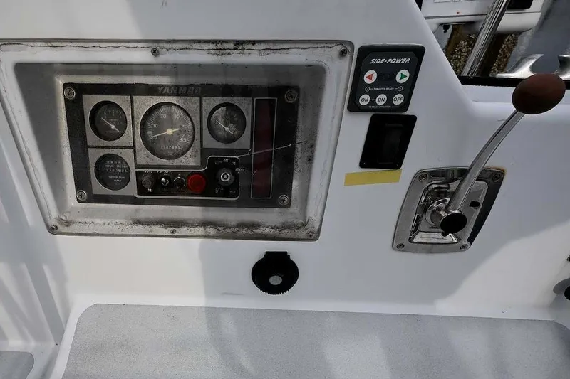 Slide: The Image of Control panel of a 1992 Santa Cruz 52 yacht with gauges and throttle lever. - 48