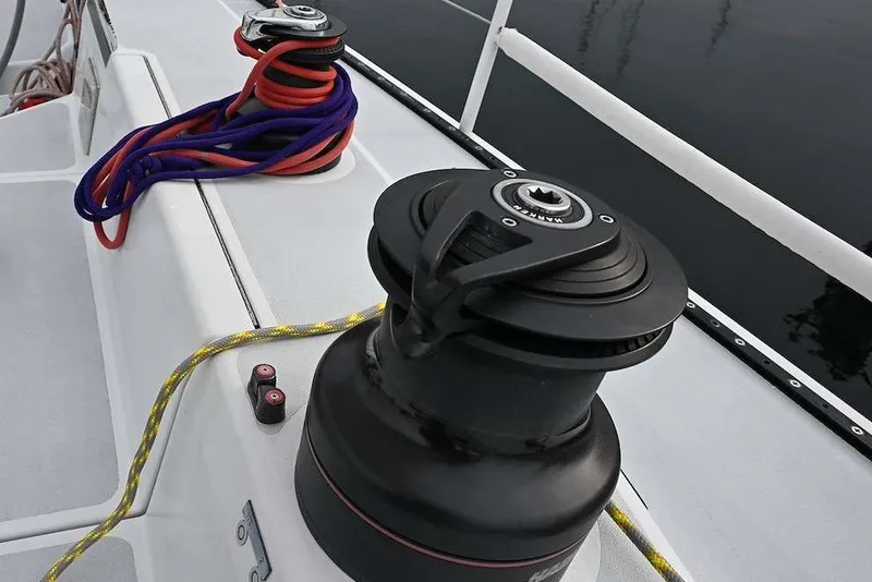 Slide: The Image of Deck of 1992 Santa Cruz 52 sailboat with winch and coiled ropes. - 35
