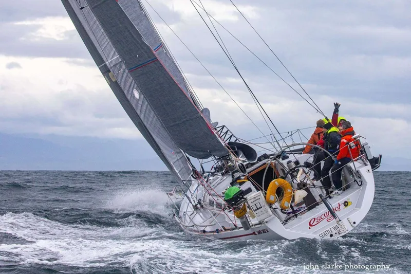 Slide: The Image of Sailing yacht Santa Cruz 52 from 1992 navigating rough seas with crew on deck. - 1
