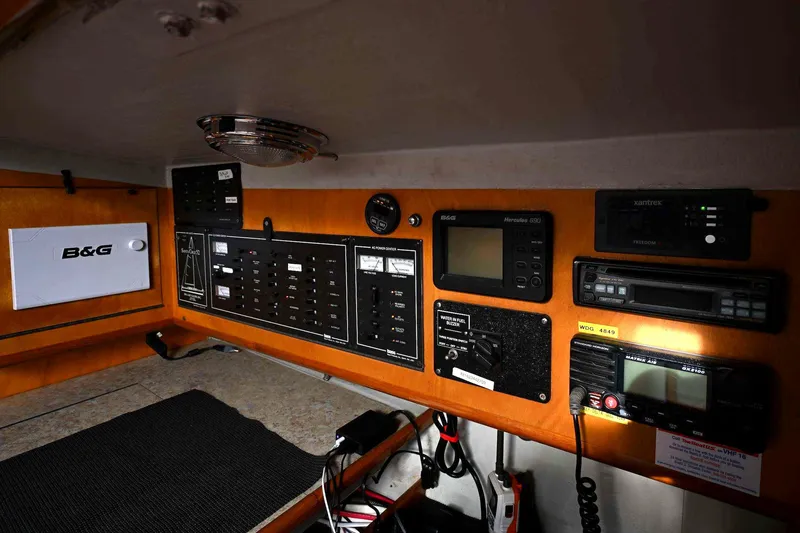 Slide: The Image of Control panel of a 1992 Santa Cruz 52 yacht with navigation and communication equipment. - 28