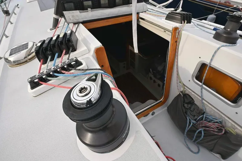 Slide: The Image of Deck view of a 1992 Santa Cruz 52 sailboat, featuring winches and colorful ropes. - 44
