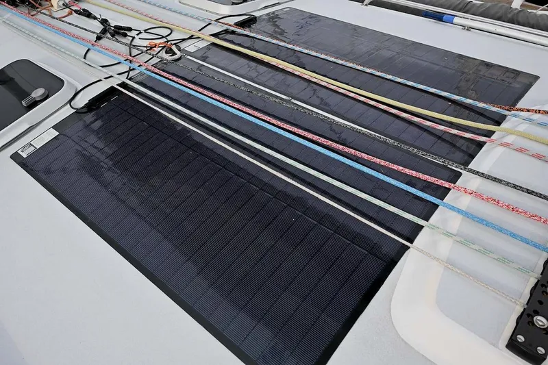 Slide: The Image of Solar panels and colorful ropes on a 1992 Santa Cruz 52 yacht deck. - 51
