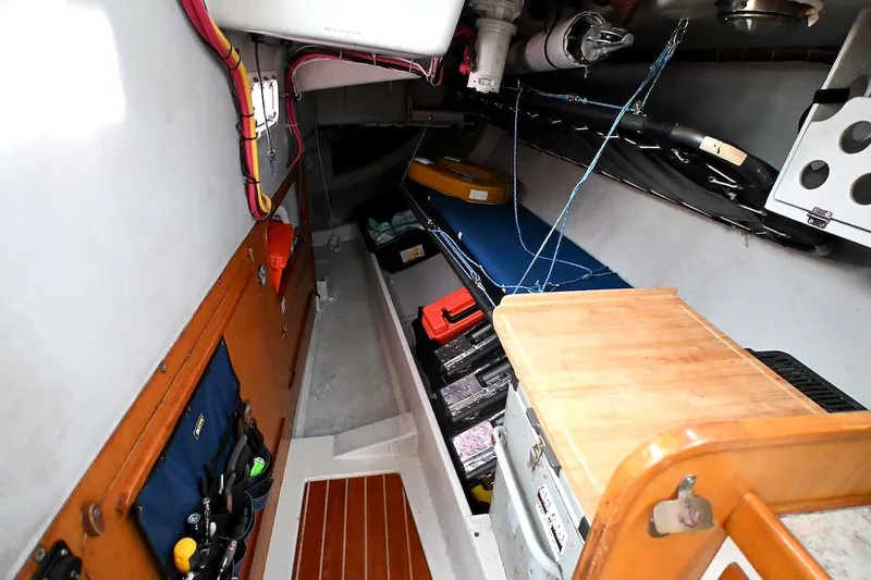 Slide: The Image of Interior of a 1992 Santa Cruz 52 sailboat, featuring organized storage and wooden accents. - 27