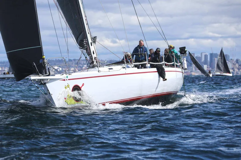 Slide: The Image of Sailing yacht Santa Cruz 52, 1992 model, navigating choppy waters with crew onboard. - 2