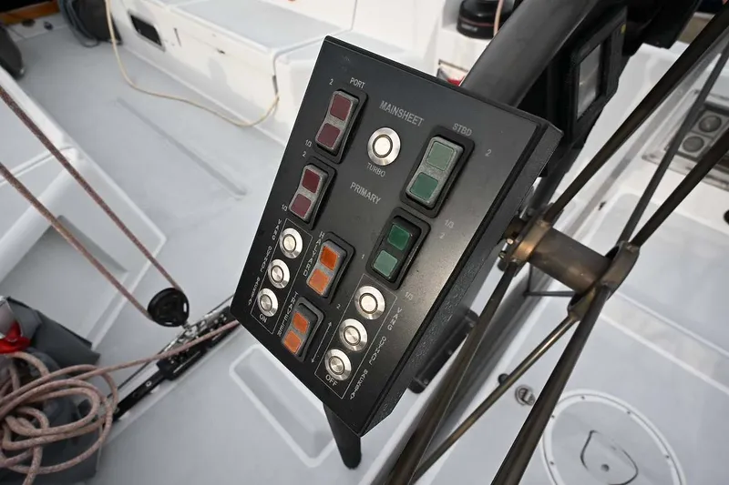 Slide: The Image of Control panel on a 1992 Santa Cruz 52 sailboat deck, featuring various switches and buttons. - 38