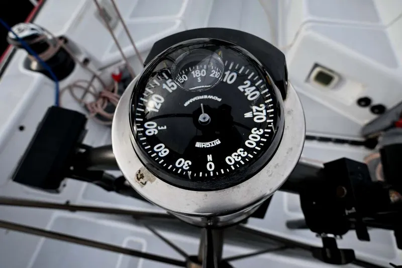 Slide: The Image of Compass on 1992 Santa Cruz 52 yacht deck, showing navigation details. - 46